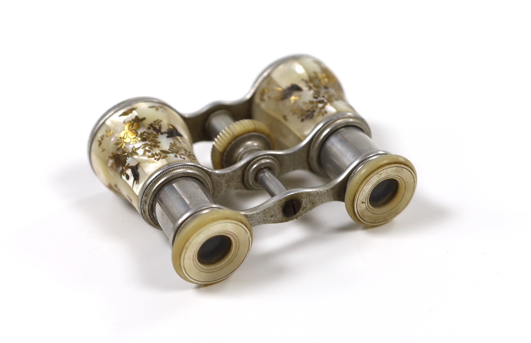 A pair of Victorian silvered metal opera glasses, with shibayama inlaid mother o'pearl lens barrels, 10cm wide
